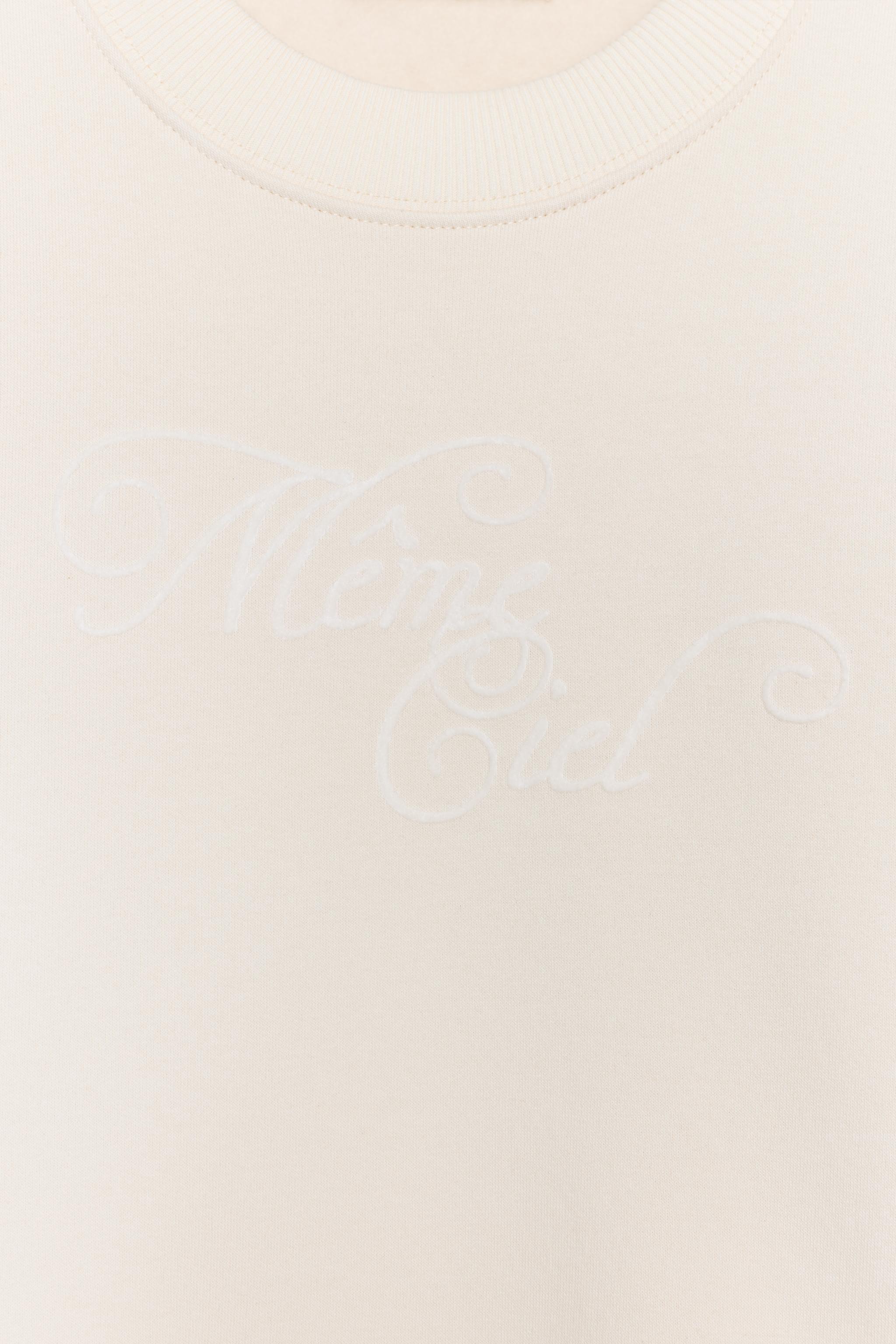 SWEAT À INSCRIPTION SUR LE DEVANT